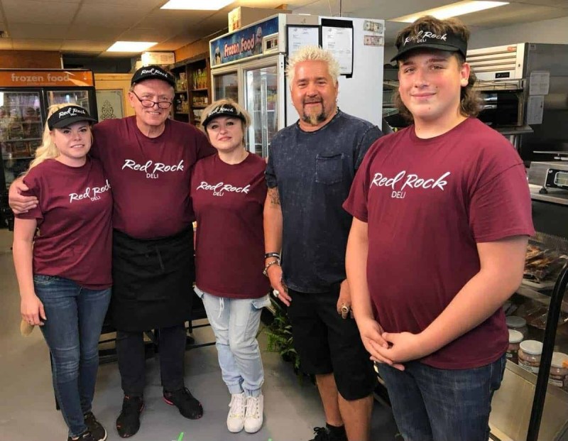 Red Rock Deli employees posing in the restaurant with Guy Fieri