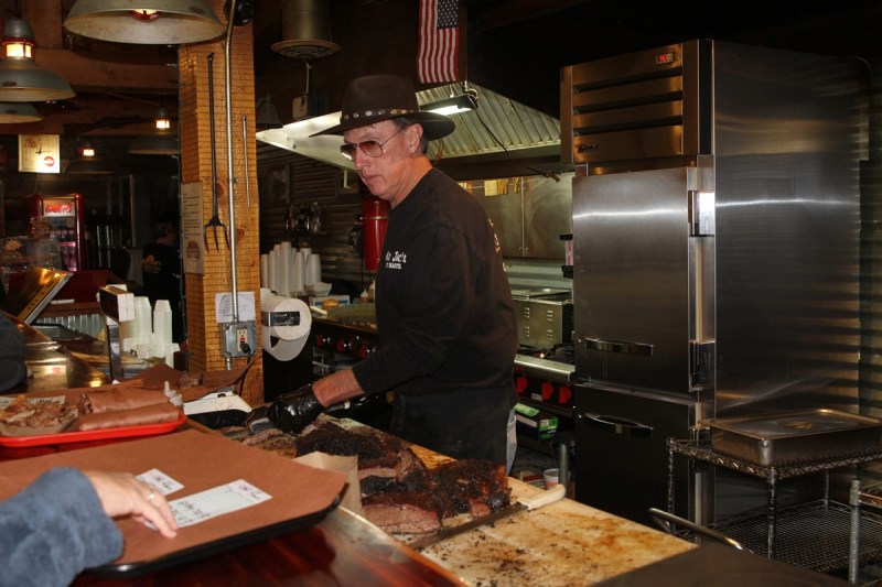 Mad Jack's Mountaintop Barbecue owner James "Jack" Jackson slicing brisket for customers