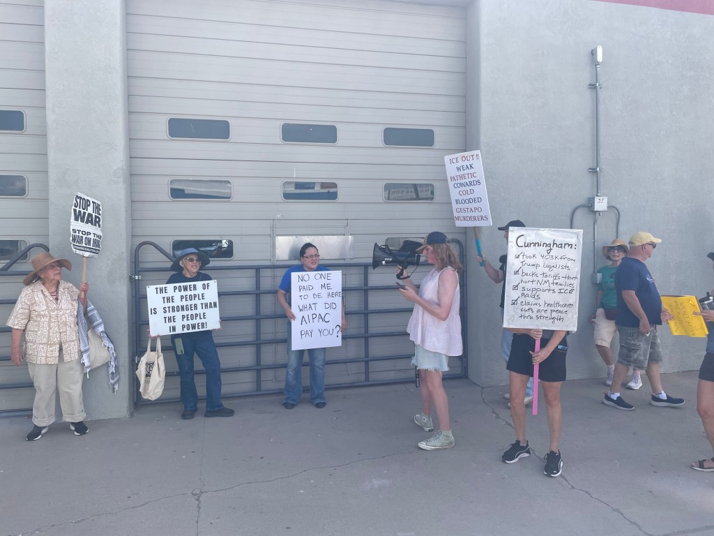 Grace Dukes leads dozens of protestors in chants against Speaker of the House Mike Johnson's appearance at Rio Bravo Brewing in Albuquerque. (Photo Credit: Courier New Mexico - Ben Montoya)