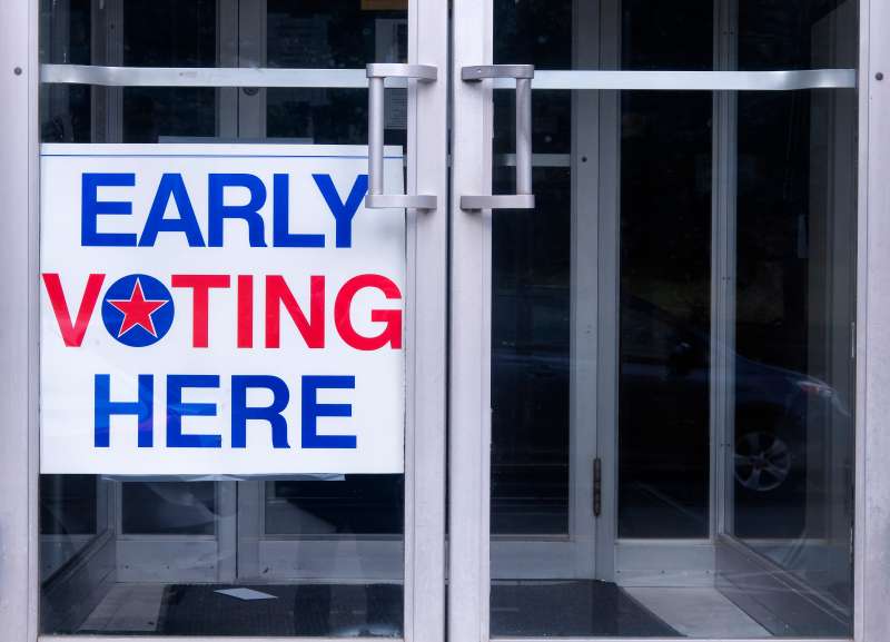 An early voting sign on a door welcoming people to vote for an democratic election in the United States of America.